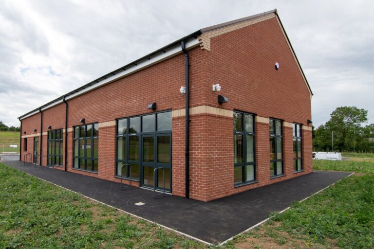 Brick-built Wavendon Community Hub with green lawn in front