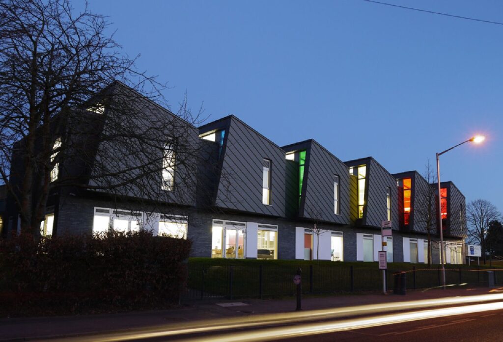 Reading Girls School at dusk with coloured window reveals lit up